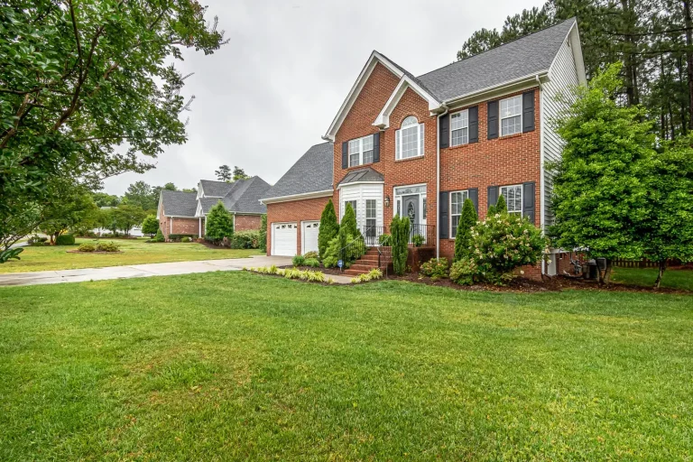 Two-story brick house with a green front lawn