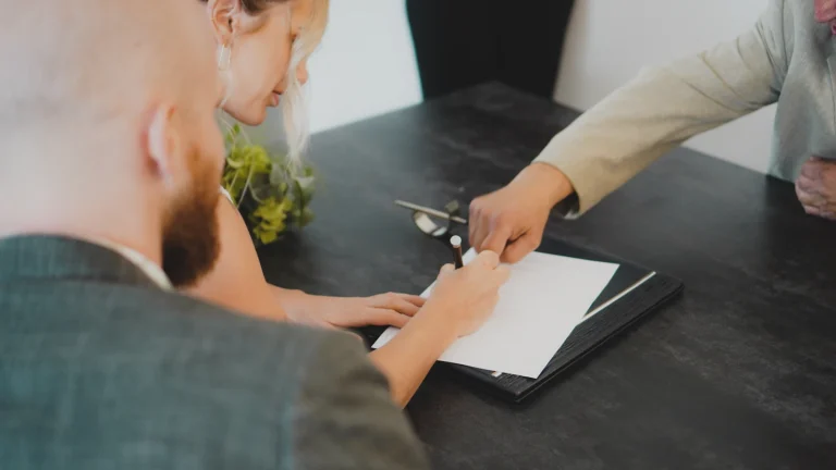Couple signing closing documents for a home sale