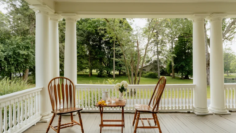 Front porch of an older family home with two chairs