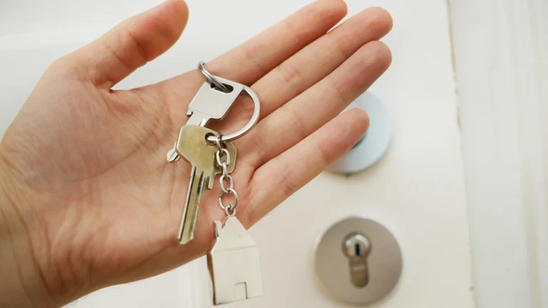 Hand holding house keys after a fast cash sale