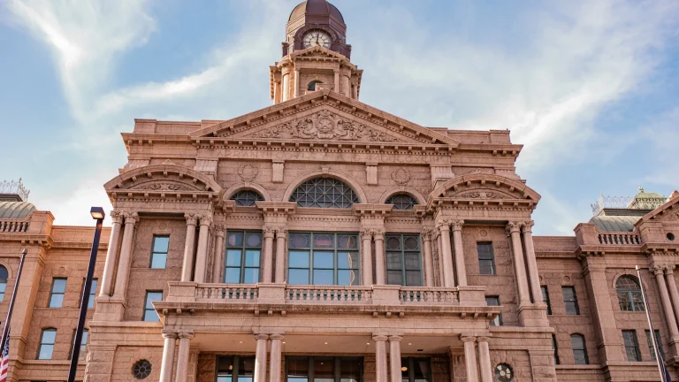 Red brick county courthouse where property liens are recorded, a key stop when selling a house with a lien